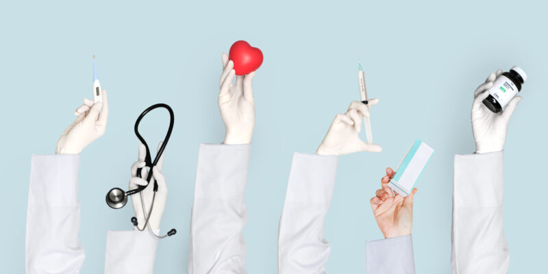 Doctors hands holding medical care objects