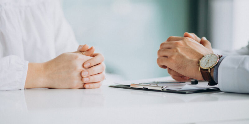Physician consulting his patient at clinic Physician consulting his patient at clinic